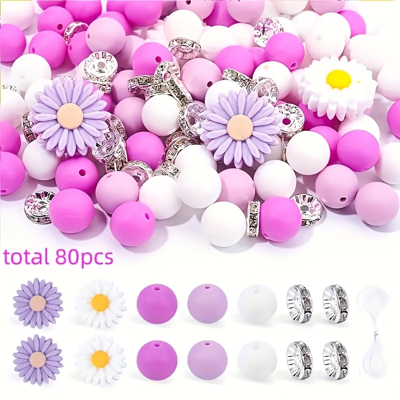 A collection of 80 craft pieces including purple and white silicone daisy focal beads, various shades of purple and white round silicone beads, silver rhinestone spacers, and white cord for jewelry making.