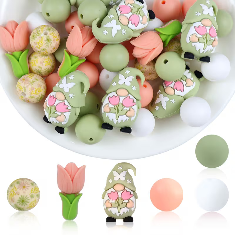 A 42-piece DIY silicone bead kit featuring sage green garden gnomes, pink tulip focals, floral printed beads, and solid sage, peach, and white rounds