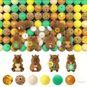 A 52-piece DIY silicone bead kit featuring four distinct cartoon capybara focal beads alongside solid yellow, mint green, cream, metallic gold round beads, sunflower pattern prints, and white spacer beads.