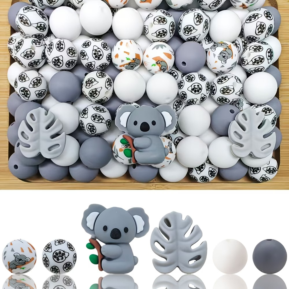 A 34-piece DIY silicone bead kit featuring a grey cartoon koala holding a branch, grey Monstera leaf focal shapes, solid grey and white round beads, and patterned beads with koala illustrations and black paw prints.