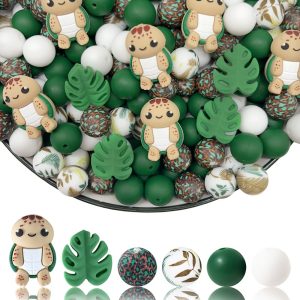 A 28-piece DIY silicone bead kit featuring cartoon sea turtle focal beads, green Monstera leaf shapes, solid green and white round beads, and botanical palm leaf and leopard patterned beads.